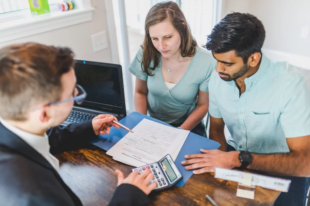 A young couple receiving expert guidance from their real estate agent to negotiate the best home deal