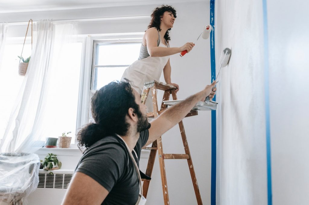 Couple Painting Their Home Walls For Home Appraisal