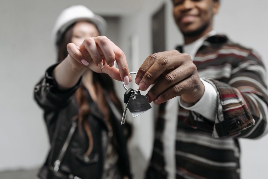 Couple holding a house key in their new home