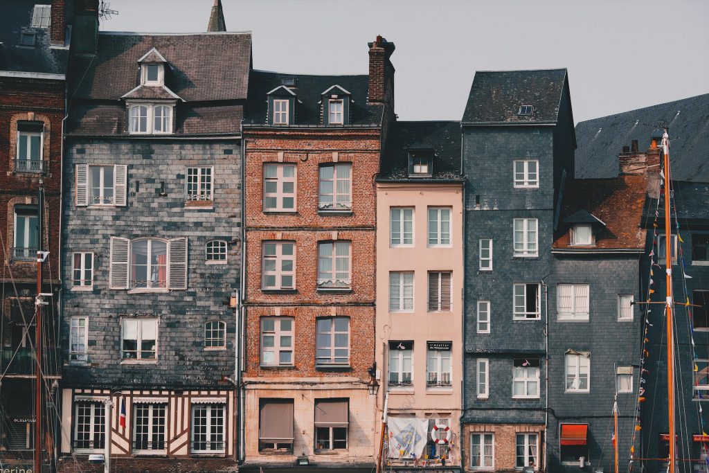 Row of colourful Victorian-style homes in a Toronto neighbourhood, showcasing historic architecture and charm.